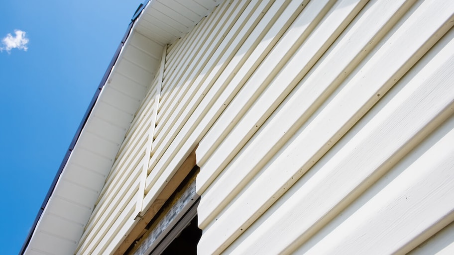 aluminum siding being installed on home exterior