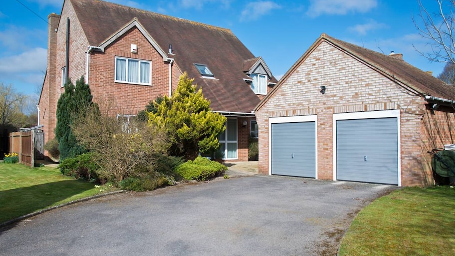 A detached garage from an exposed brick house