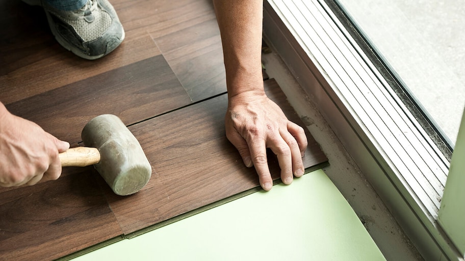 pergo flooring being installed on floor of home
