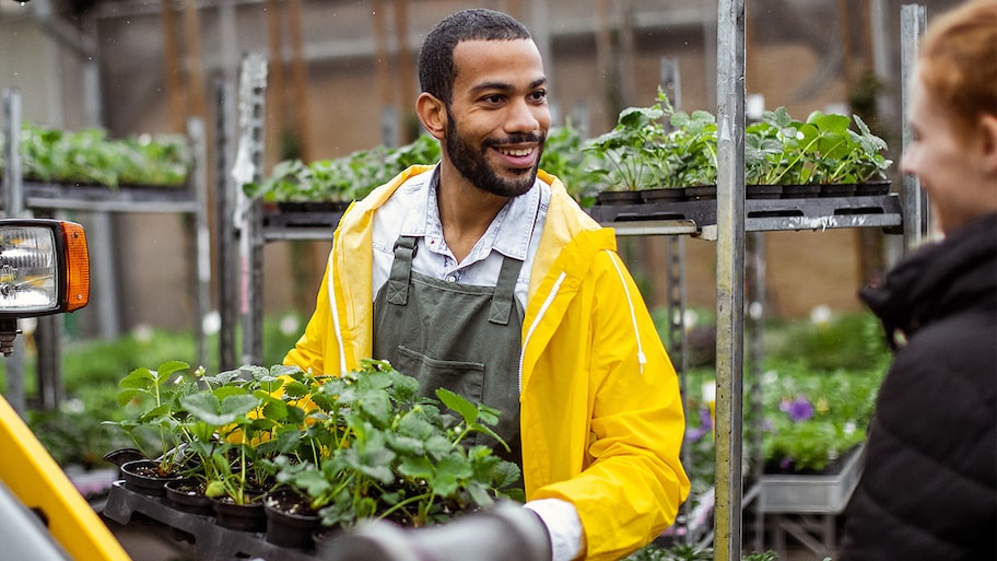 Landscaper at garden center with plants