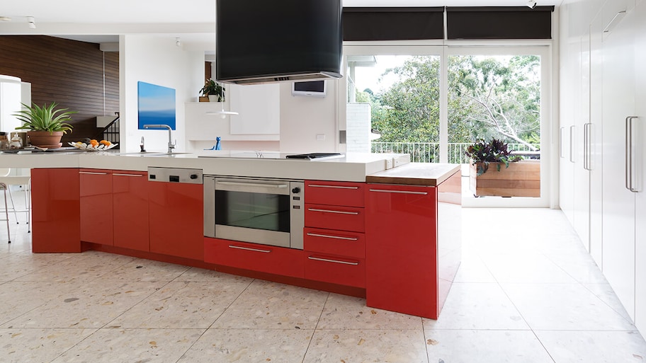 modern kitchen with terrazzo flooring and red island