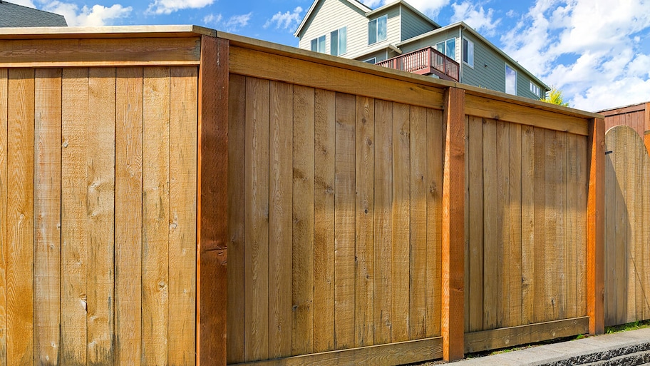 new wooden privacy fence built around backyard